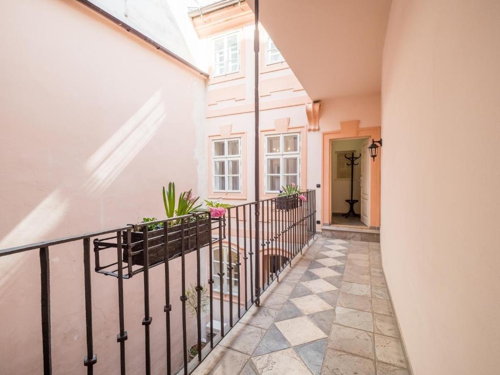 Inner courtyard walkway leading to the entrance of Chateau 9 Apartments by Adrez