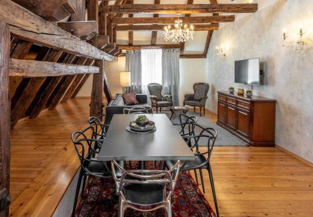 Living and dining area of the Two-Bedroom Apartment with Terrace with historic wooden beams